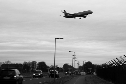Jumbo jet above the highway on the final approach to Amsterdam Airport