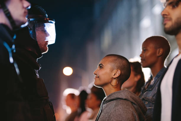 istock Woman smiling at the policeman during a rally 1215740422