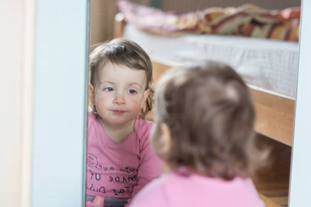 istock Little girl with reflection in a mirror 1215741389