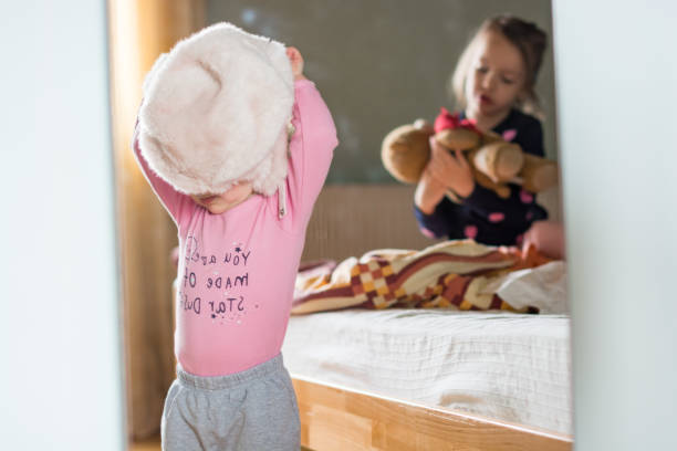istock Little girl with reflection in a mirror 1215741900
