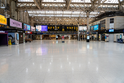 London, UK - March 29th 2020: Empty railway station with closed shops in central London during lockdown