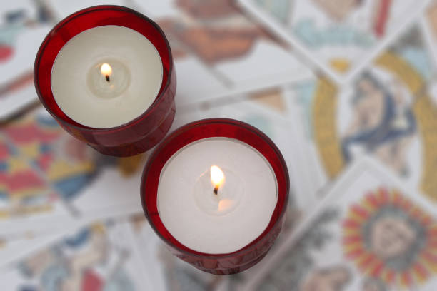 istock Burning candles on a set of esoteric cards 1215742102