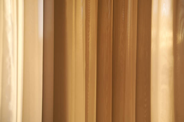 Full frame image of draped vibrant orange cotton fabric as used by buddhist monks.