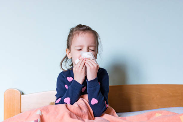 istock Little girl cleaning her nose 1215745347