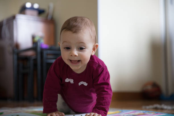 istock Baby girl crawling 1215746398