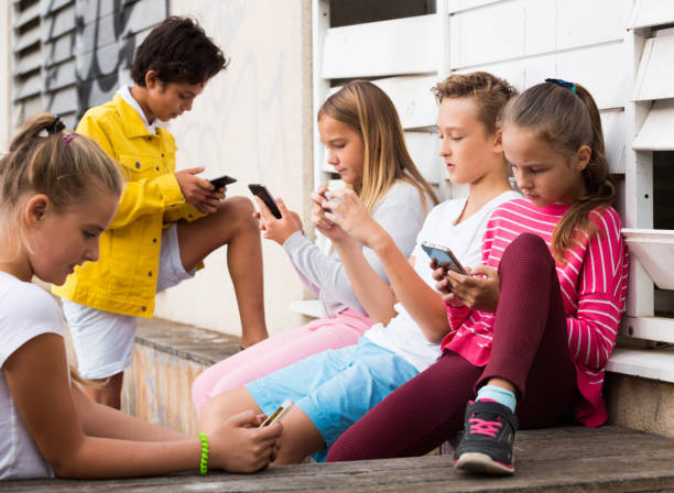 istock Cheerful children are chatting on their smartphone 1215746788