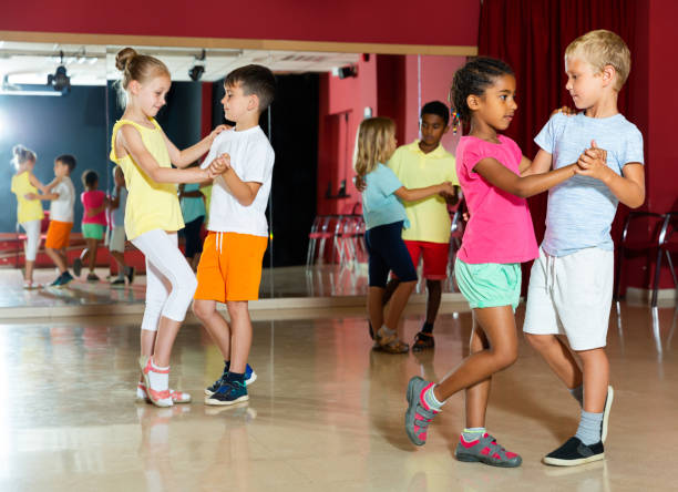 istock Group of cheery children dancing salsa dance 1215746823