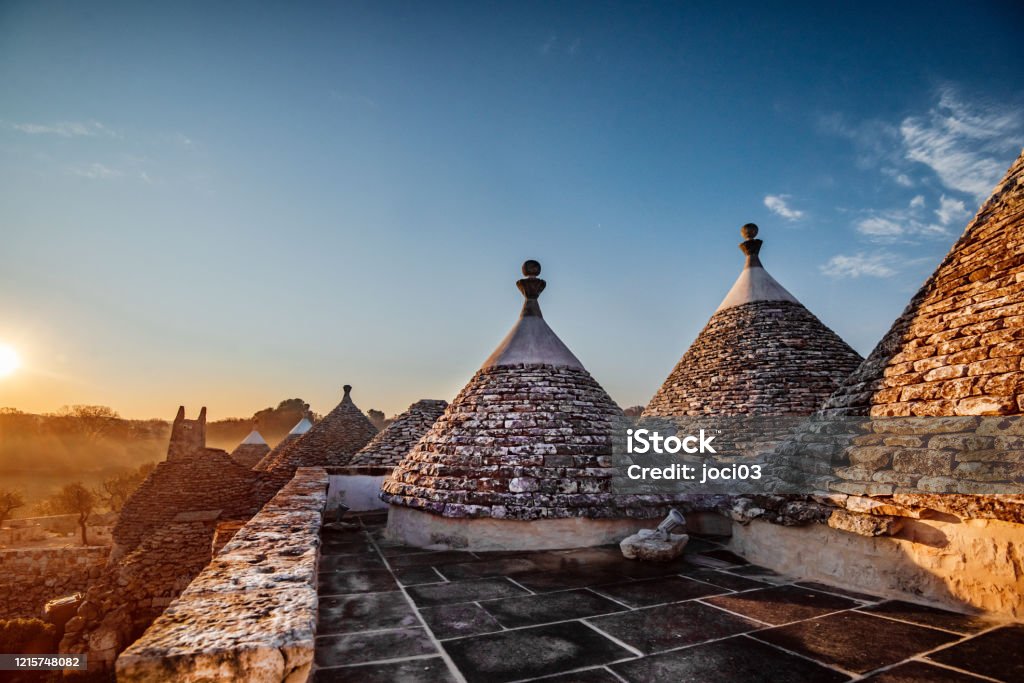 The Trulli Houses of Puglia Old traditional village of trulli. Stone houses built in the typical circular shape with cone roofs, the southern region of Italy Puglia Stock Photo