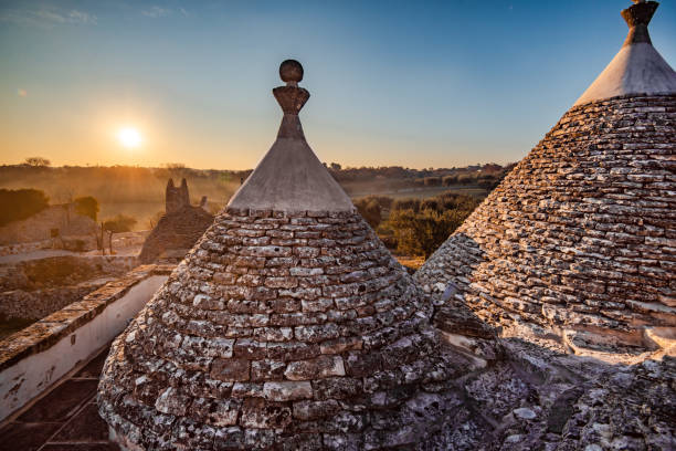The Trulli Houses of Puglia Old traditional village of trulli. Stone houses built in the typical circular shape with cone roofs, the southern region of Italy trulli house photos stock pictures, royalty-free photos & images