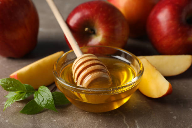 istock Apples and honey on gray background, close up 1215749612