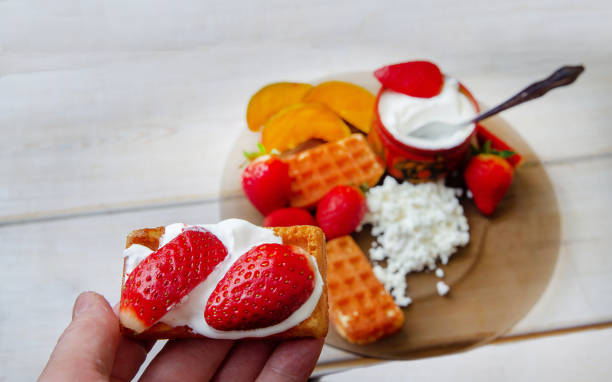 istock Waffle with Strawberry in hand 1215749730