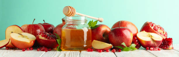 istock Apples, pomegranate and honey against mint background 1215749877