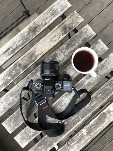 istock Travel camera and coffee cup on wooden table 1215750058