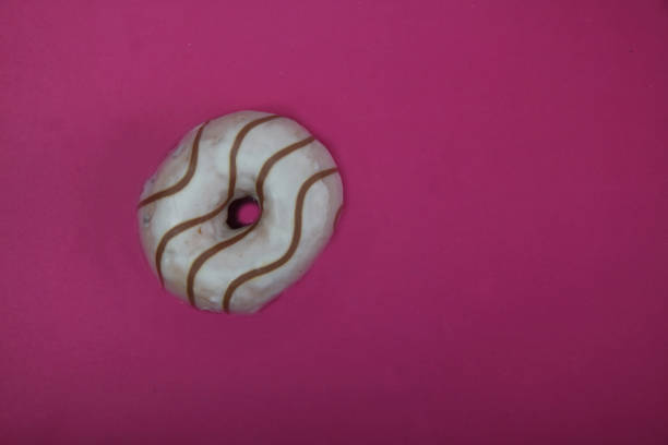 istock donut decorated with chocolate isolated on red background flat lay 1215750383