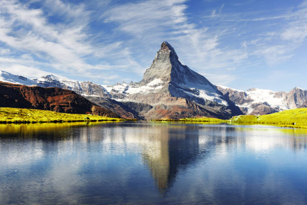 Picturesque view of Matterhorn peak and Stellisee lake in Swiss Alps Picturesque view of Matterhorn Cervino peak and Stellisee lake in Swiss Alps. Day photo with blue sky. Zermatt resort location, Switzerland. Landscape photography matterhorn stock pictures, royalty-free photos & images