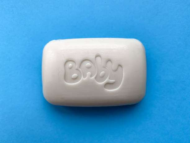 Baby solid soap for hands on a blue background. Hygiene and care.