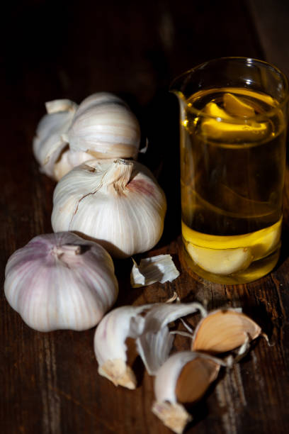 istock Garlic on a wooden background. Food on table 1215752636