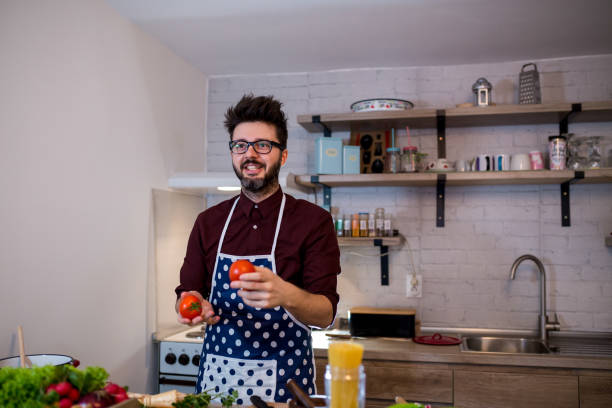 istock Young man cooking romantic dinner at home 1215752715