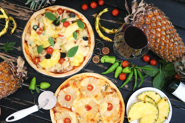 Pineapple pizza served with wine stock photo