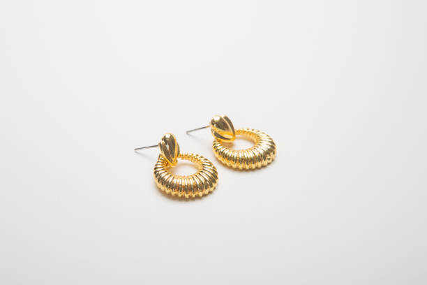 istock Golden earrings isolated on white background 1215755359