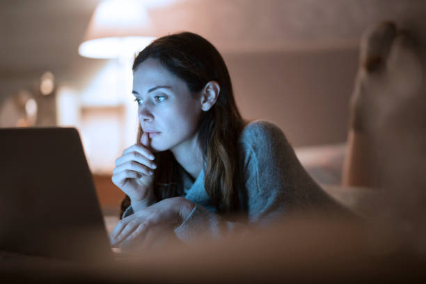istock Home laptop evening woman 1215755459