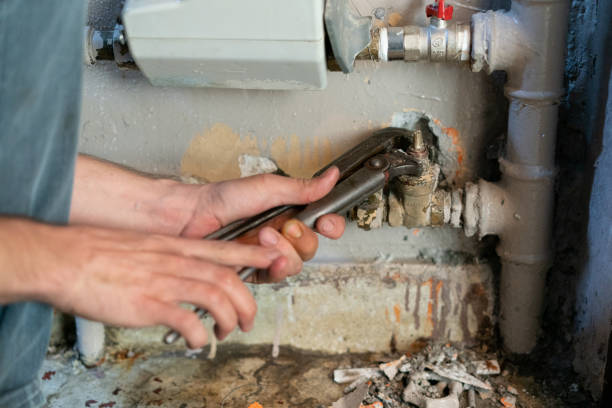 istock Worker fixing the pipes with Adjustable Wrench 1215755782