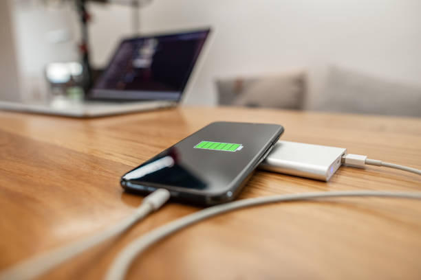 istock Smart phone on power bank near laptop on table 1215756005