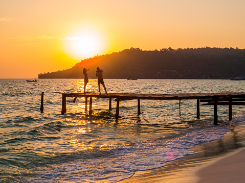 Koh Rong, Cambodia - January 13, 2020: Couple on the beach at sunset on the  Sok San Village.