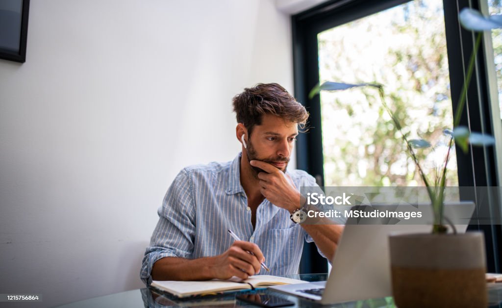 Man woriking from home. Young elegant man working from home. Men Stock Photo