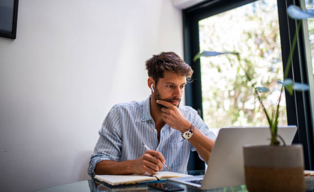 Man woriking from home. Young elegant man working from home. homework stock pictures, royalty-free photos & images