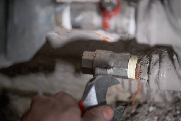 istock Worker fixing the pipes with Adjustable Wrench 1215757705