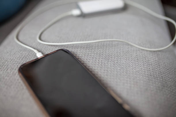 istock Close up smart phone charging,plugged into power bank 1215760151