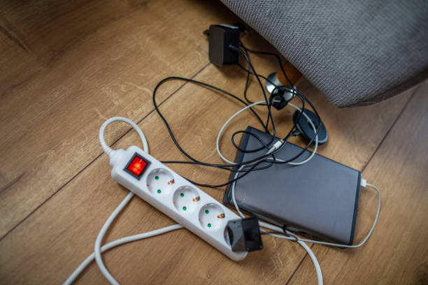 istock Power bank and cords plugged into plug adapter on floor 1215760188