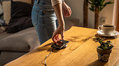 Woman placing smart phone on wireless charger