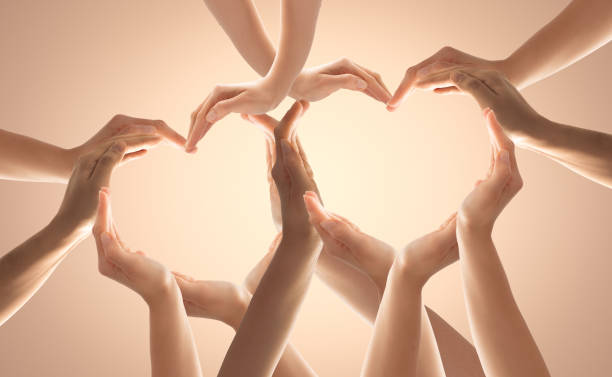 The concept of unity, cooperation, teamwork and charity. Symbol and shape of heart created from hands.The concept of unity, cooperation, partnership, teamwork and charity. diversity hands forming heart stock pictures, royalty-free photos & images