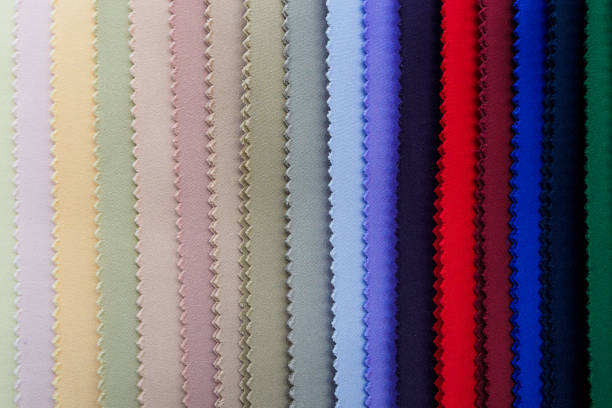 Multi-color knitted fabric samples in vertical position. Woven texture and background.