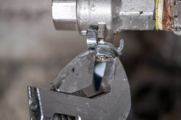 istock Worker fixing the pipes with Adjustable Wrench 1215761769