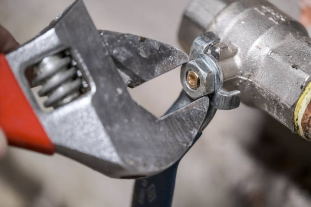 istock Worker fixing the pipes with Adjustable Wrench 1215761918