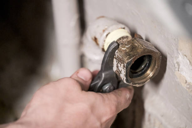 istock Worker fixing the pipes with Adjustable Wrench 1215762971