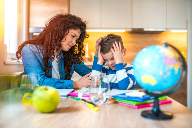 istock Mother helping son with homework. 1215764835