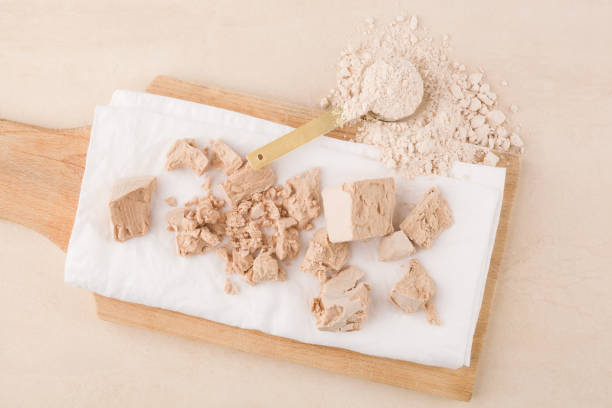 istock Yeast cubes and flour for bread making on beige background. 1215764889