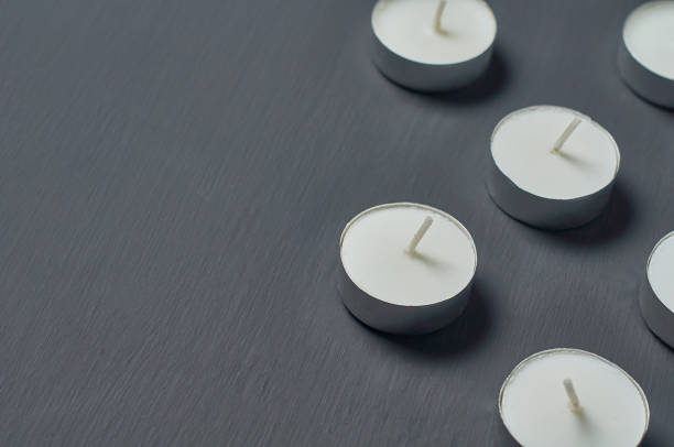 istock Many circle candles in metal holder on dark concrete surface 1215765365