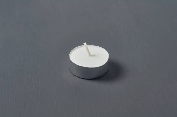 istock One circle candle in metal holder on dark concrete surface 1215765367