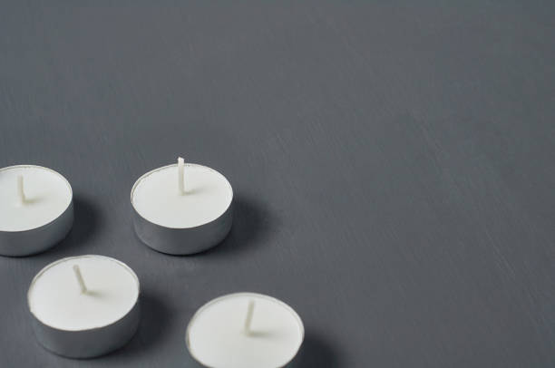 istock Many circle candles in metal holder on dark concrete surface 1215765372