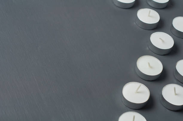 istock Many circle candles in metal holder on dark concrete surface 1215765376