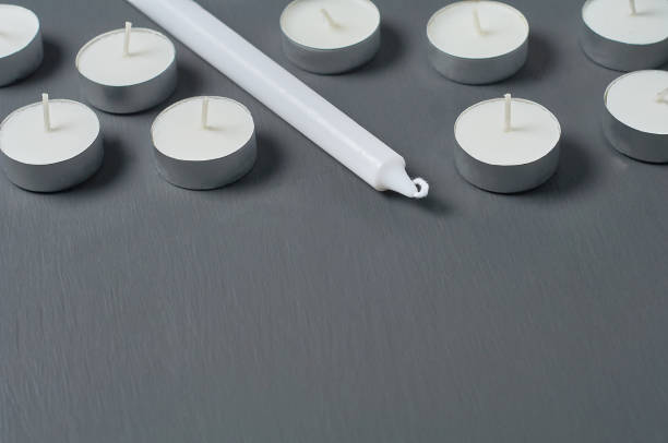 istock Circle in metal holder and  long candles on dark concrete surface 1215765384