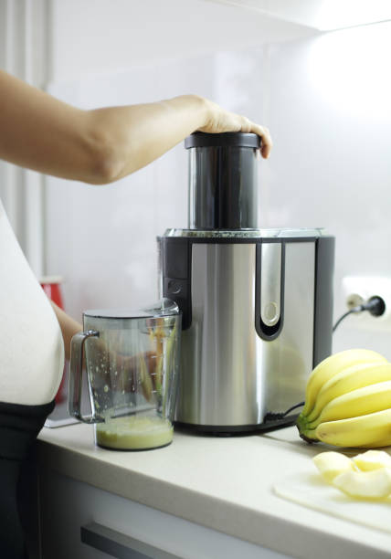istock Pregnant woman at kitchen 1215765546