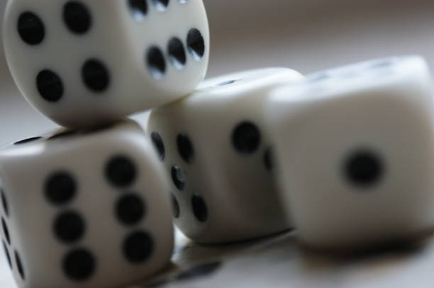 istock dice game many pieces closeup  four and six black and white 1215767239
