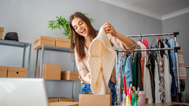 istock Women packing package with her products that she selling online. 1215768296