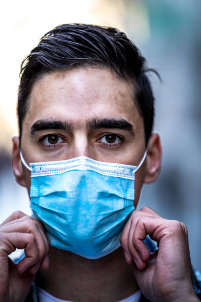 istock Scared young man with  medical mask 1215769414